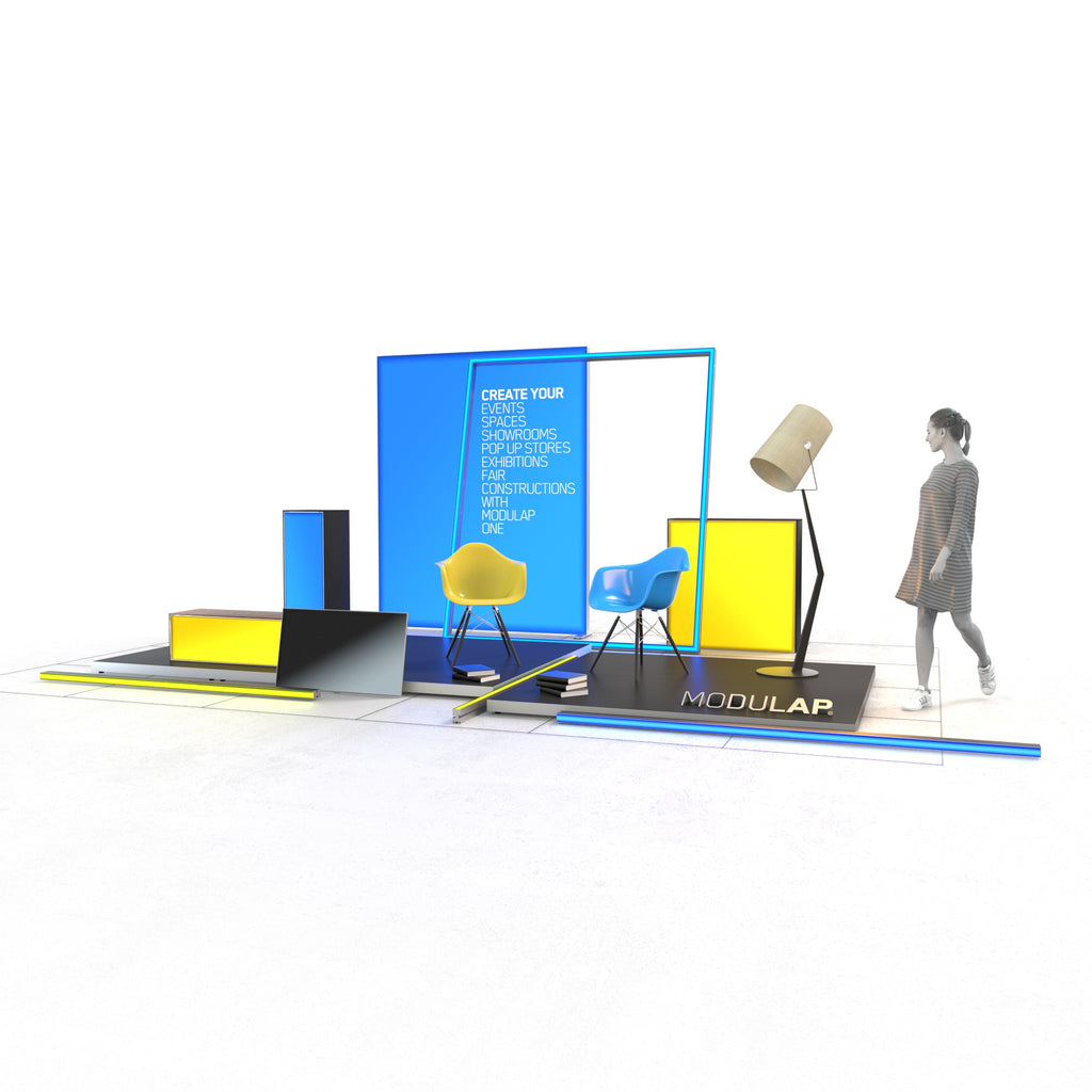 Ein moderner Event-Stand von Modulap, der aus farbenfrohen Elementen wie gelben und blauen LED-Wänden besteht. Zwei Stühle und eine große Lampe schaffen eine einladende Atmosphäre. Eine Person geht an dem Stand vorbei, der durch klare Linien und lebendige Farben eine auffällige Präsentationsfläche bietet.